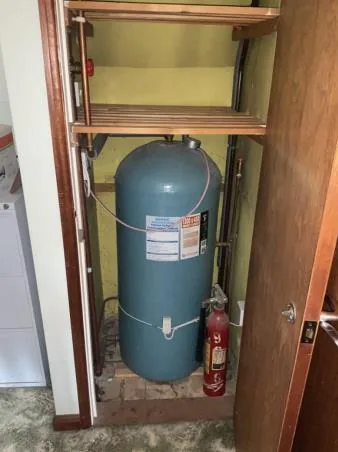 The old 162-litre hot water cylinder in the airing cupboard before replacement