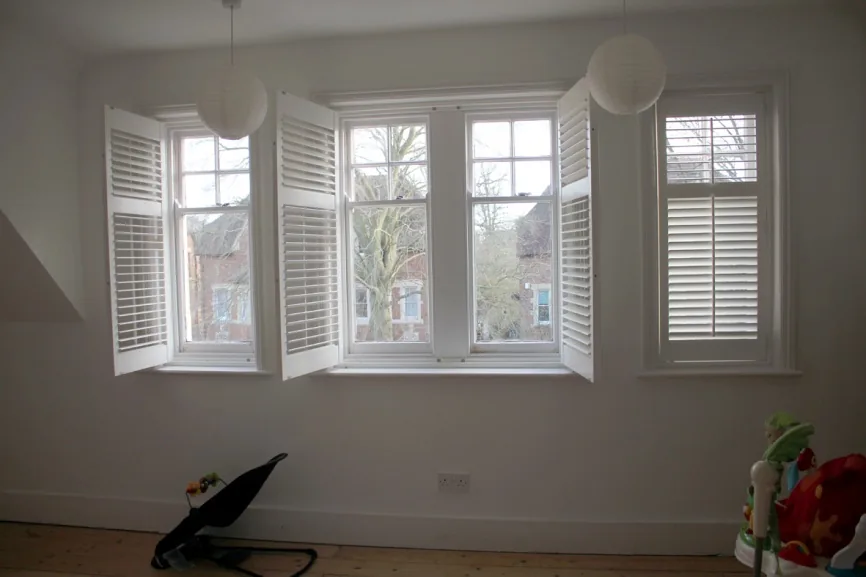 A top-floor bay with shuttered sash windows
